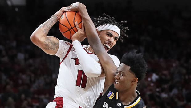 Arkansas Razorbacks forward Jalen Graham and San Jose State Spartans guard JT Elder attempt to gain possession during the second half at Bud Walton Arena. Arkansas won 99-58.